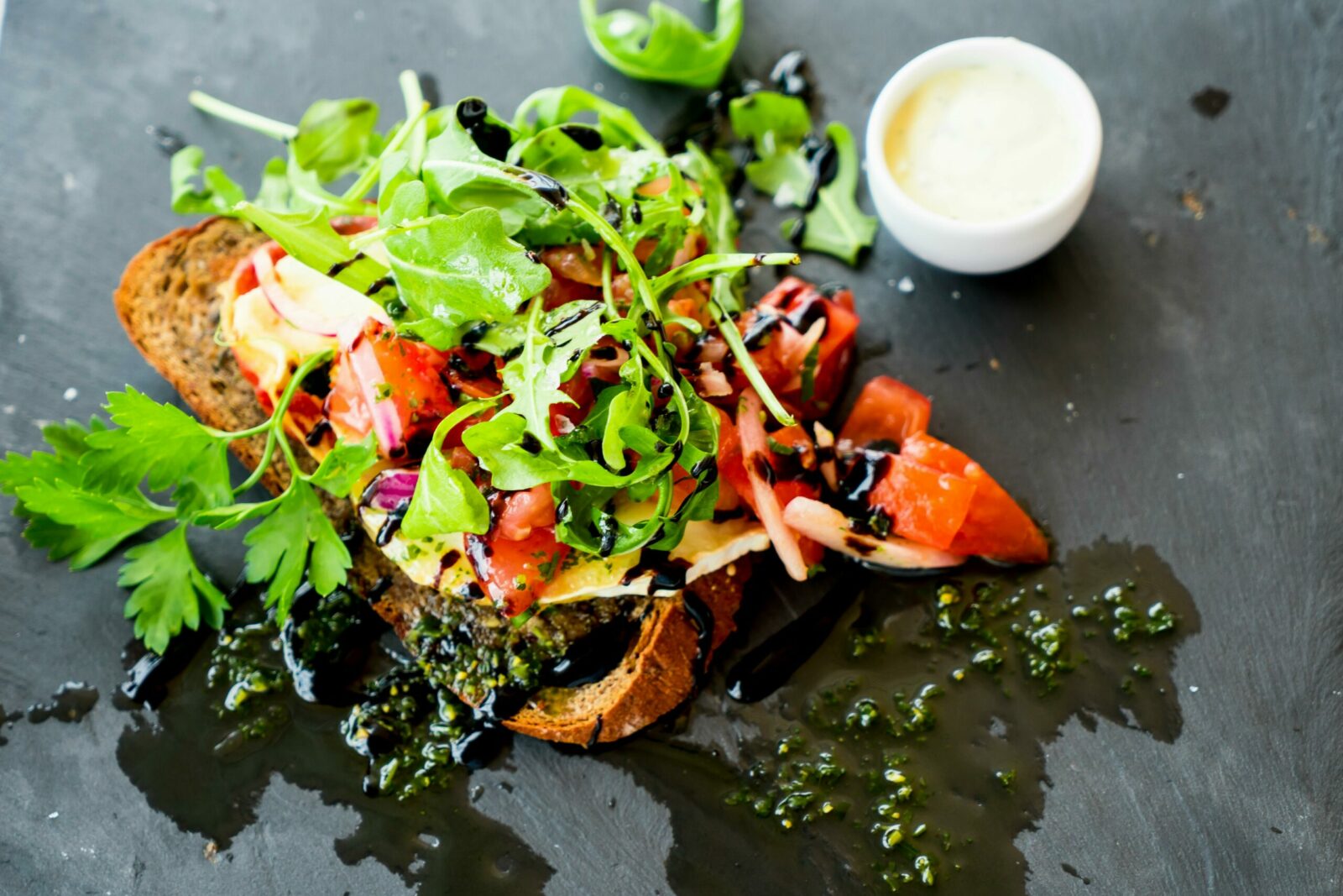 Delicious bruschetta with fresh herbs, tomatoes, and balsamic sauce.
